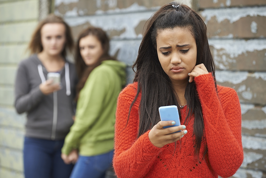 Teenage girl being bullied by other teenage girls