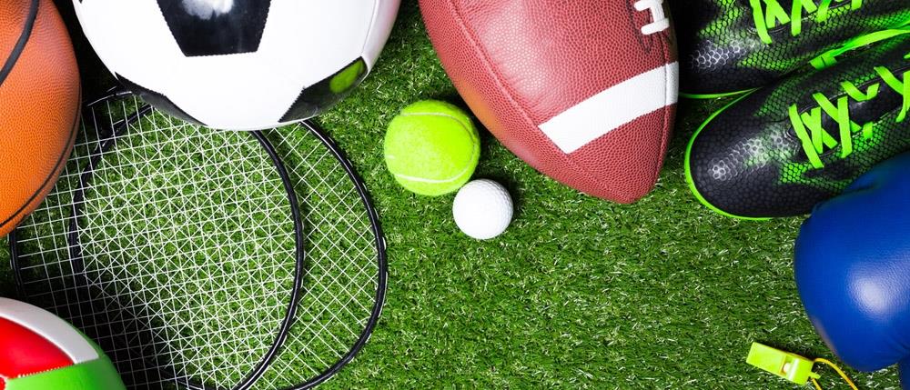 photo of various sports equipment on grass