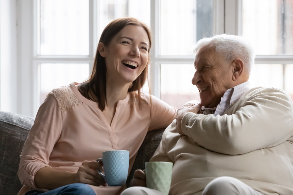 grown daughter and mature father having fun enjoy tea talk